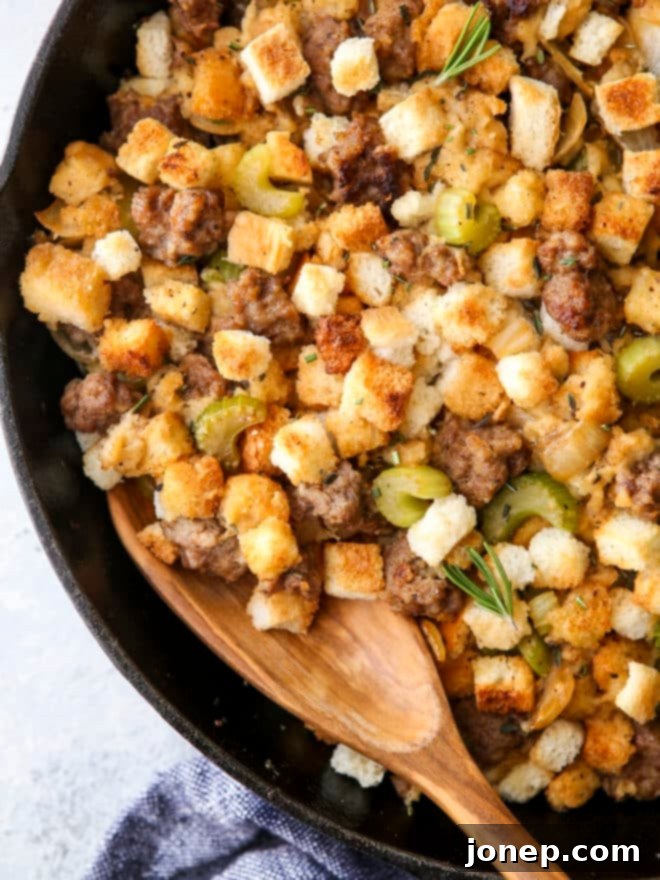 spoon in skillet stovetop sausage stuffing close-up, showing detailed texture