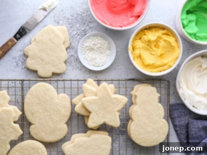 baked sugar cookies and bowls of frosting and sprinkles
