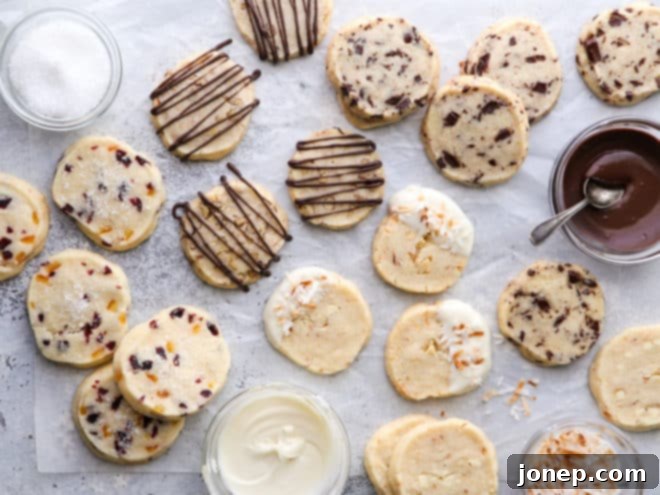An enticing arrangement of shortbread cookies, some artfully drizzled with chocolate, others sprinkled with coarse sugar or flaky sea salt.