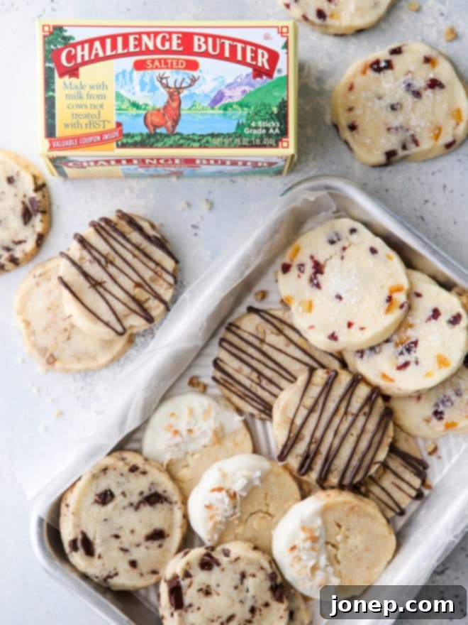 A beautiful display of the four distinct shortbread cookie variations on a tray, with a box of premium Challenge Butter prominently in the background.