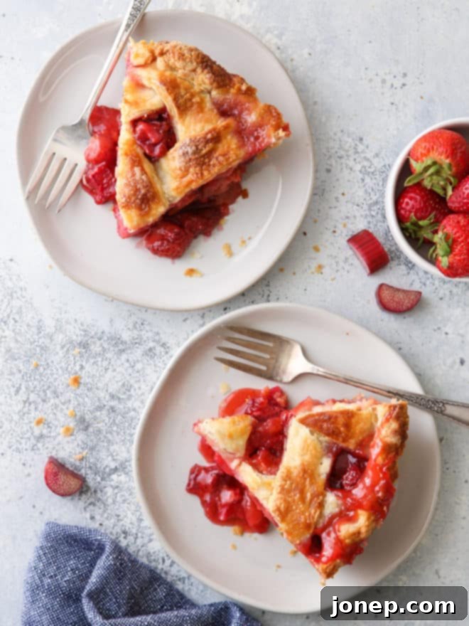 Sweet and Tangy Strawberry Rhubarb Pie 9 2 slices of strawberry rhubarb pie on plates with napkin