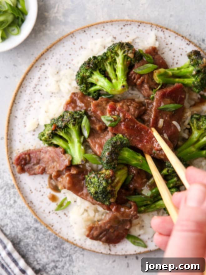 stir fry beef with broccoli and chopstick