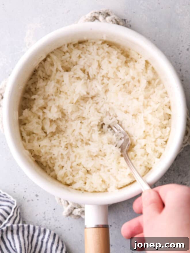 fluffing steamed rice in a pot