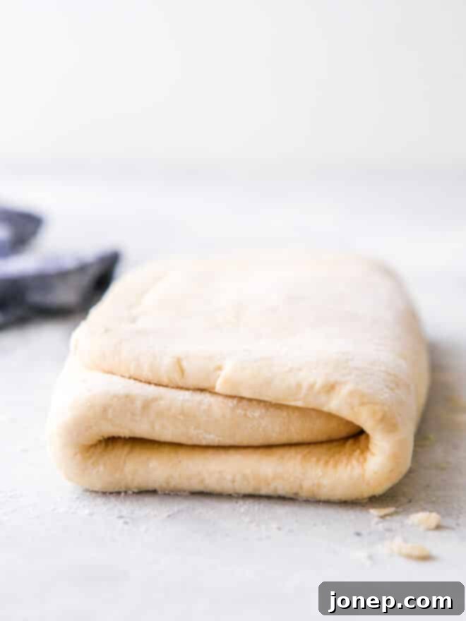 Beautifully folded puff pastry dough, showcasing the potential for flaky layers.