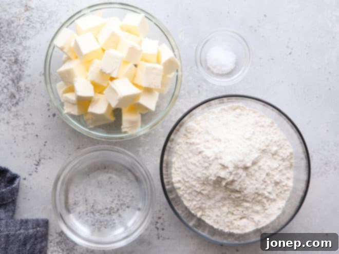 Key ingredients for homemade puff pastry: flour, salt, cold butter, and water.