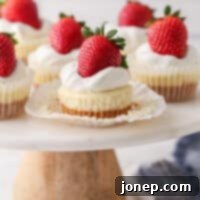 Bite-Sized Cheesecake Delights 10 Mini cheesecakes on a cake stand, one with wrapper pulled down, ready to be eaten.