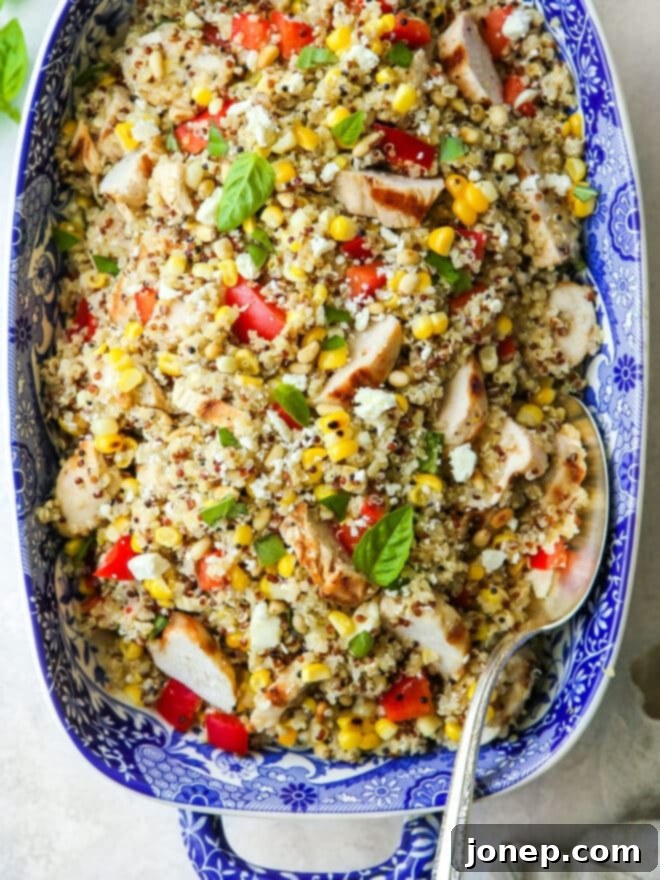 Close-up view of the grilled chicken quinoa salad, highlighting the textures of quinoa, chicken, corn, and feta