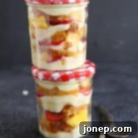 Sun-Kissed Rum Trifles with Cloudlike Coconut Cream 2 Tropical Rum Trifle with Coconut Cream, featuring layers of fruit, cake, and creamy custard