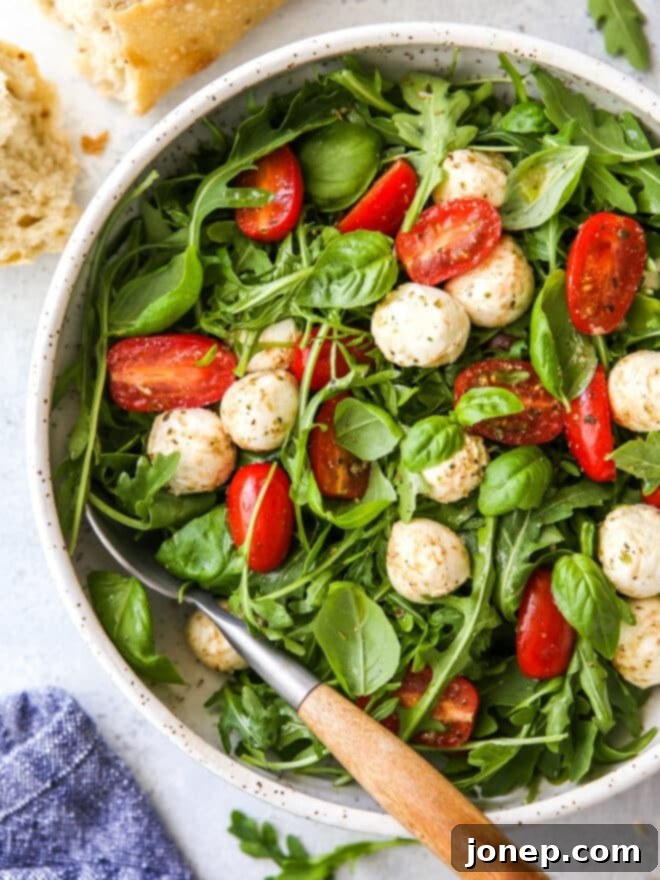 closeup of arugula caprese salad in a bowl