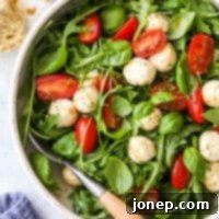 Peppery Arugula Caprese 7 closeup of arugula caprese salad in a bowl
