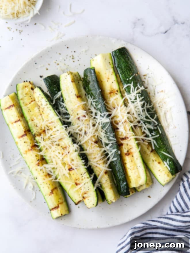 Parmesan-Crusted Grilled Zucchini 2 grilled parmesan zucchini on a plate