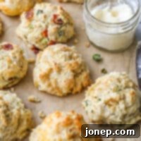 buttermilk drop biscuits with different mixins on a sheet of parchment closeup
