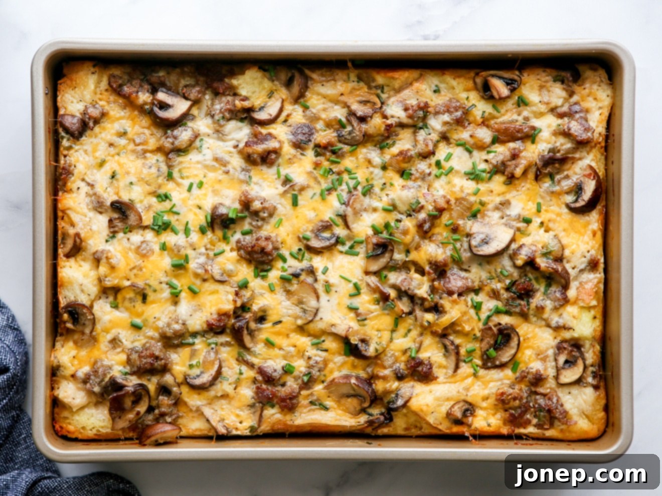 Beautifully baked sausage and mushroom breakfast casserole, golden and puffed, ready to be served
