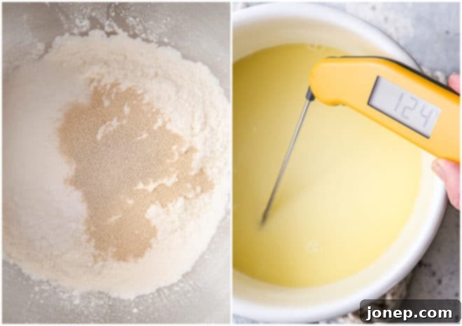Close-up shot of wet and dry ingredients for dinner rolls being mixed together in a stand mixer bowl with a dough hook.