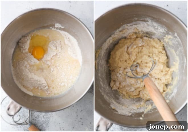 A stand mixer actively kneading dinner roll dough with a dough hook, showing the transition from wet to a cohesive dough.