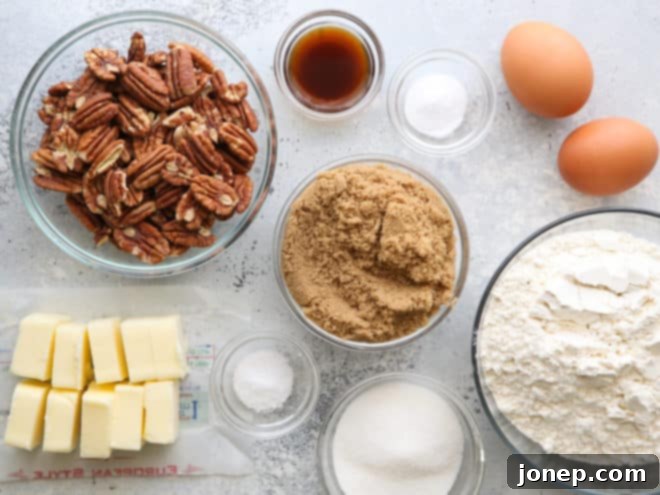 All the essential ingredients for brown butter pecan cookies laid out on a clean surface, including butter, sugars, flour, eggs, and pecans.