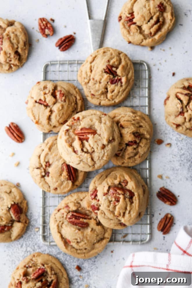 A stack of delicious brown butter pecan cookies, ready to be enjoyed, with a soft focus on the texture and golden color.