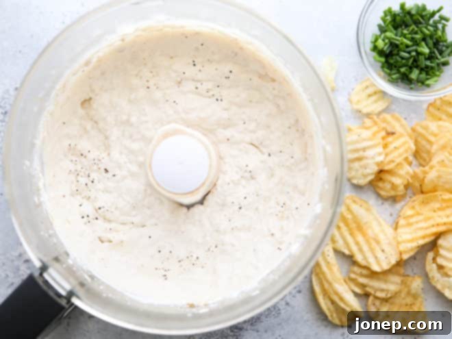 french onion dip being blended in a food processor, showing creamy texture