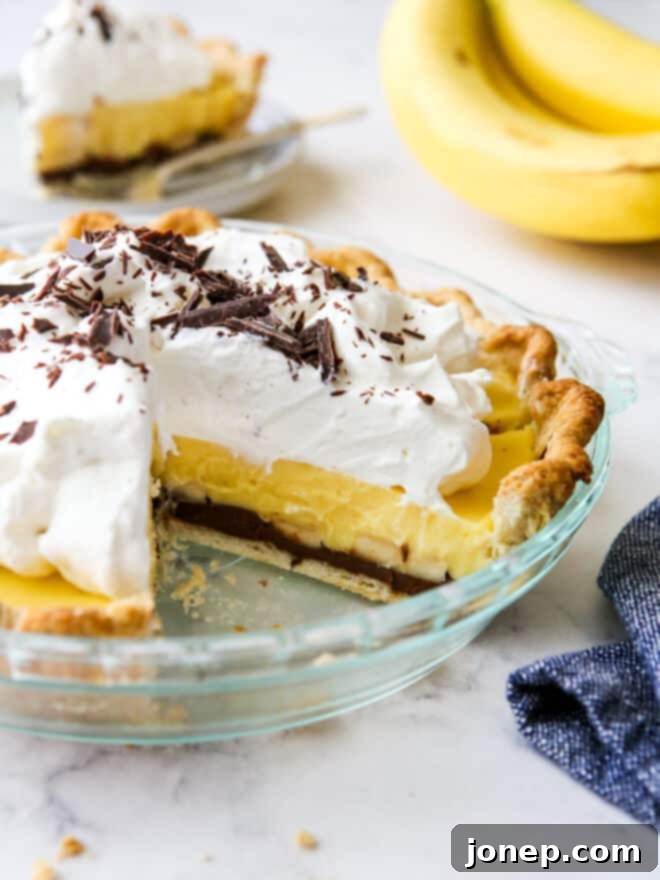 chocolate bottom banana cream pie with slices taken out so you can see the layers