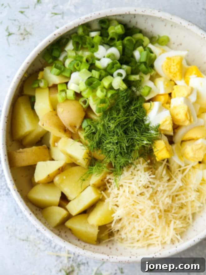 Adding potato salad ingredients to a large mixing bowl