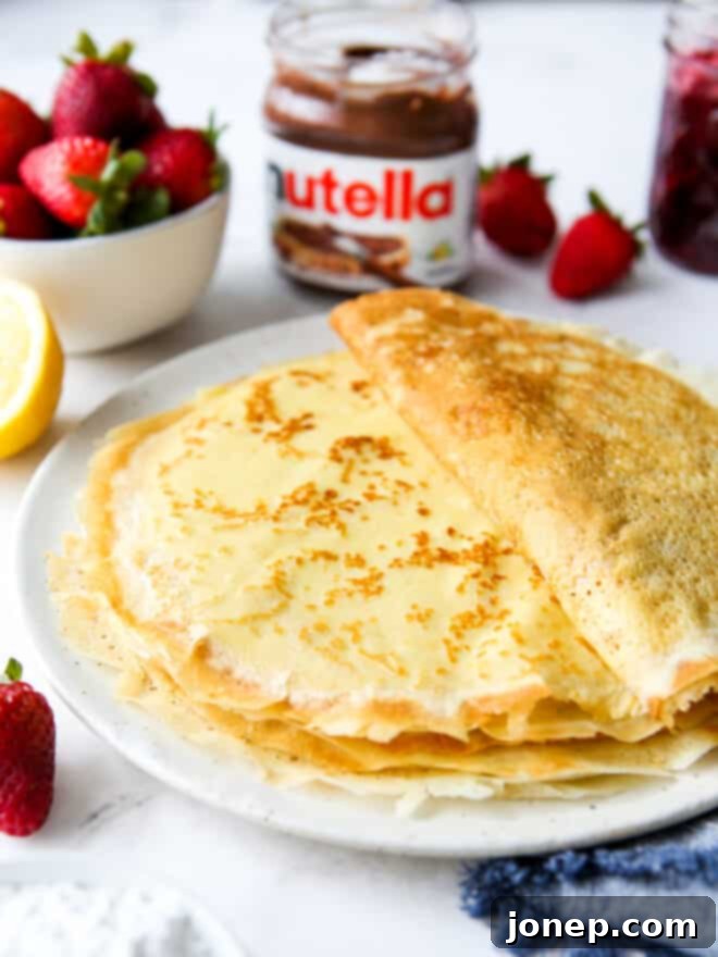 Crafting Perfect Homemade Crepes 2 a stack of homemade crepes on a plate with toppings