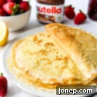 Crafting Perfect Homemade Crepes 9 a stack of homemade crepes on a plate with toppings