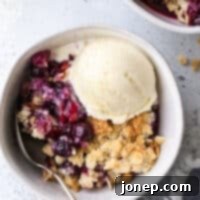 Sweet Berry Almond Delight 7 A close-up image of a delicious Blueberry Almond Crisp, highlighting the golden crunchy topping and the vibrant fruit filling, presented as a recipe card image.