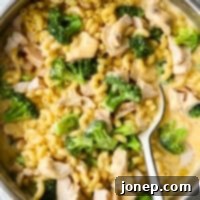 Creamy Chicken Broccoli Macaroni and Cheese stirred in a large skillet