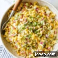 Creamy Classic Macaroni Salad 6 macaroni salad in bowl with large spoon