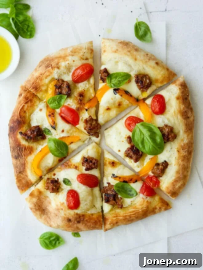 sliced italian sausage pizza with peppers and tomatoes
