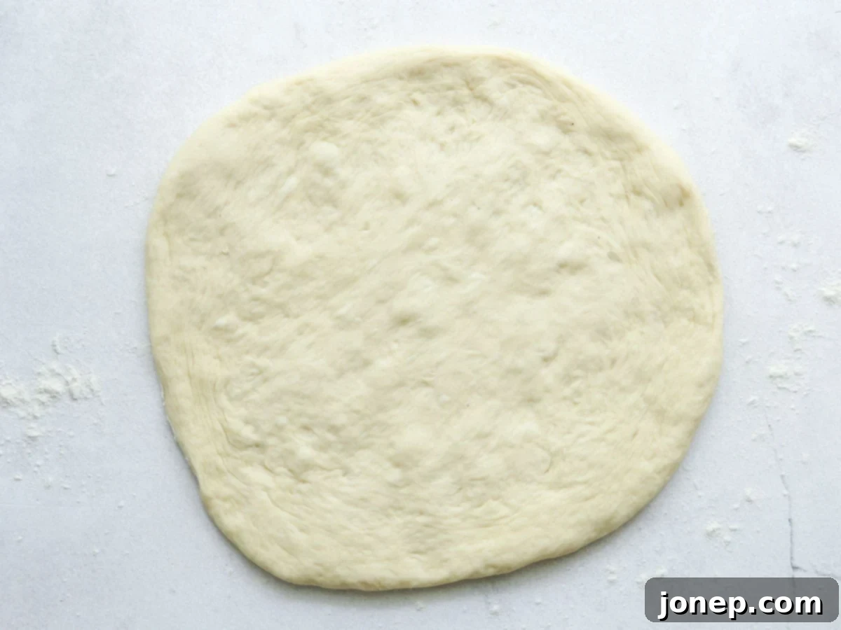 rolled out pizza dough on the counter