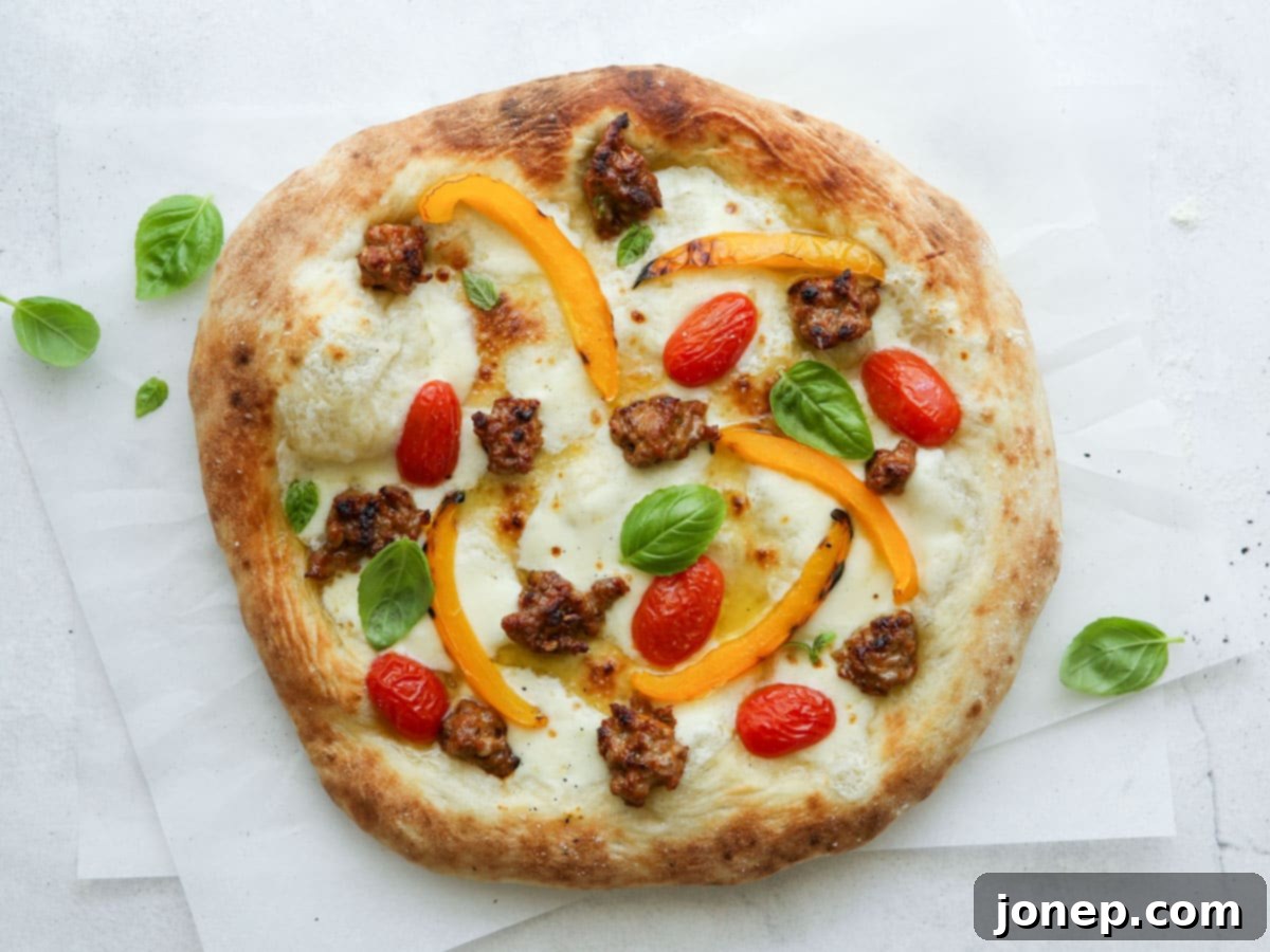 baked Italian sausage pizza before slicing