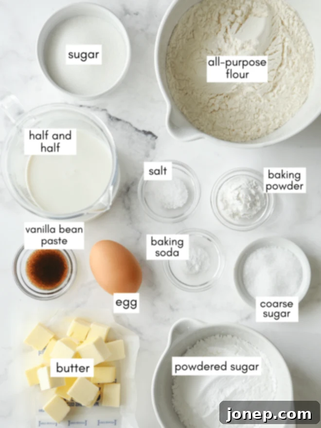A collection of fresh ingredients laid out, including flour, sugar, butter, and vanilla, ready for baking vanilla bean scones.