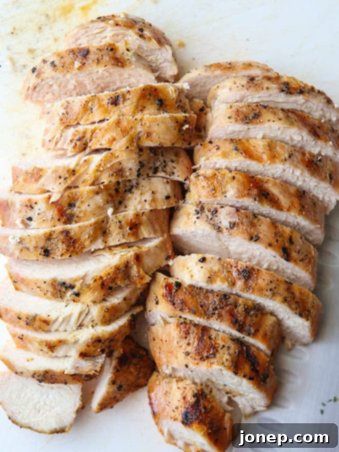 Close-up of grilled chicken, vegetables, and bread in a panzanella salad