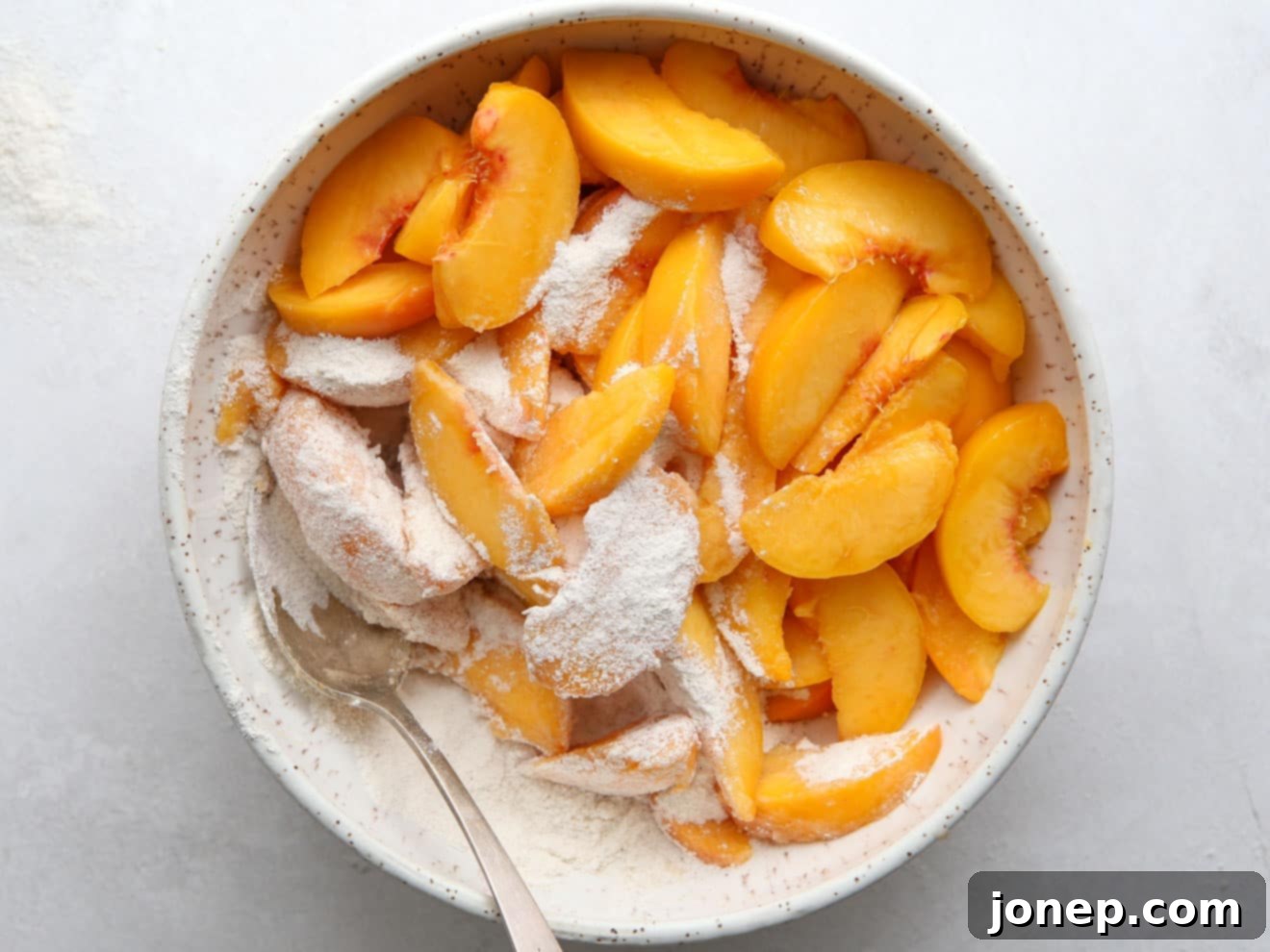 mixing peach pie filling ingredients in a bowl