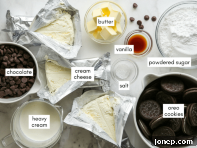 Effortless Chocolate Cheesecake Bliss 4 Assortment of ingredients for no-bake chocolate cheesecake, including Oreos, butter, cream cheese, chocolate, and cream.
