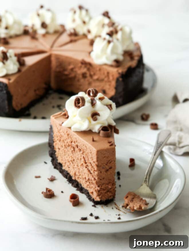 Effortless Chocolate Cheesecake Bliss 8 Close-up of a person taking a bite out of a slice of no-bake chocolate cheesecake.