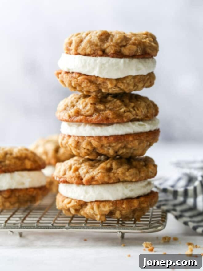 Dreamy Oatmeal Cream Pie Cookies 2 Stack of homemade oatmeal cream pie cookies on a wire rack, perfectly golden and inviting.