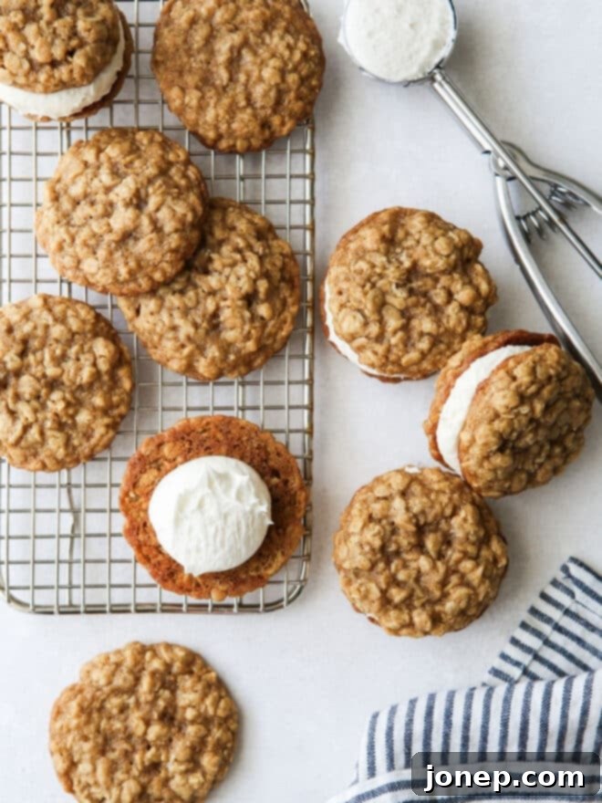Hands assembling an oatmeal cream pie, placing filling on one cookie and topping with another.