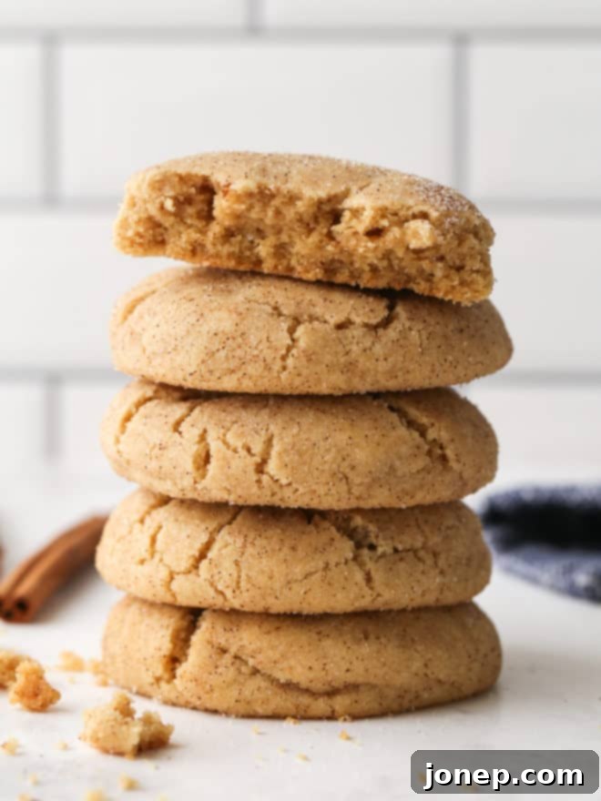 Caramelized Snickerdoodles 7 Stack of brown butter snickerdoodles, with one cookie broken in half to show its soft interior