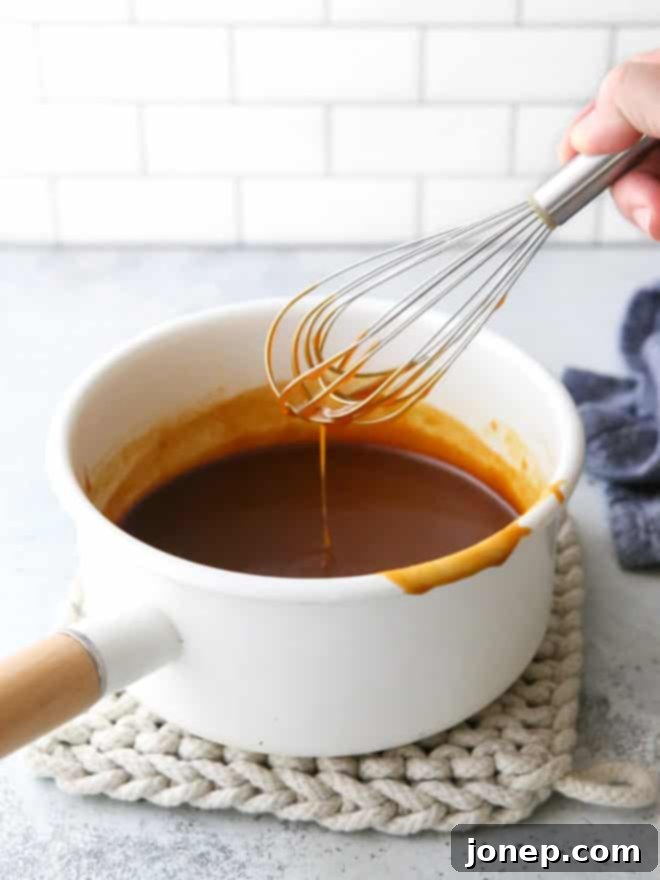 Perfect Homemade Caramel 10 whisking homemade caramel sauce in a pan