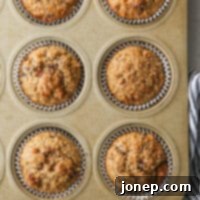 Closeup of a freshly baked oat bran muffin with visible mix-ins