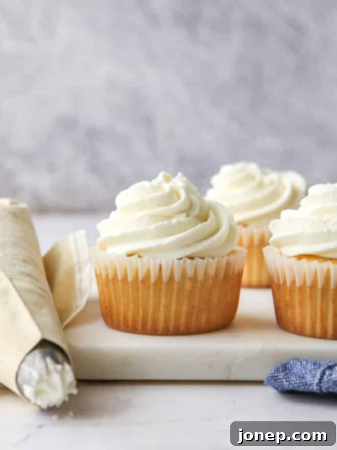 Piping elegant Chantilly cream frosting onto delicious cupcakes
