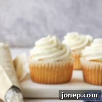 piping chantilly cream frosting onto cupcakes