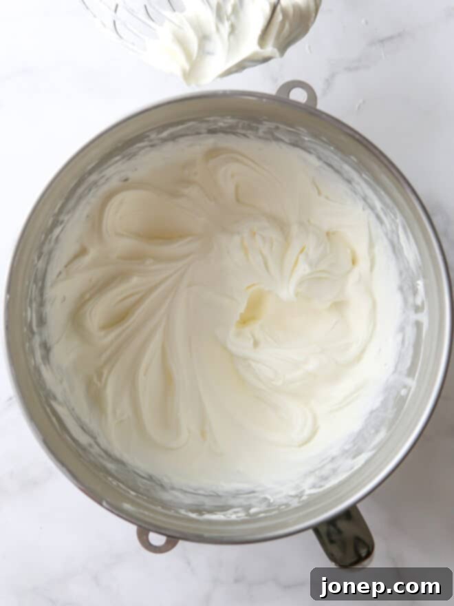 A bowl of freshly whipped, airy Chantilly cream frosting, ready for use