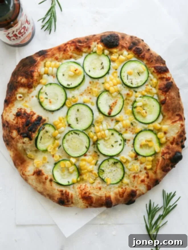 Sweet Corn and Zucchini Pizza 7 Baked zucchini corn pizza on counter, whole and golden brown