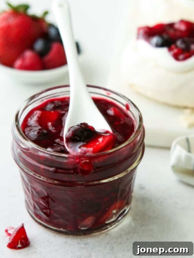 Sweet Berry Medley 3 A jar filled with vibrant homemade berry compote, showcasing its rich color and chunky texture.