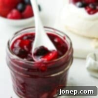 Sweet Berry Medley 7 A jar of freshly made berry compote, showcasing its deep red and purple hues, ready for serving.