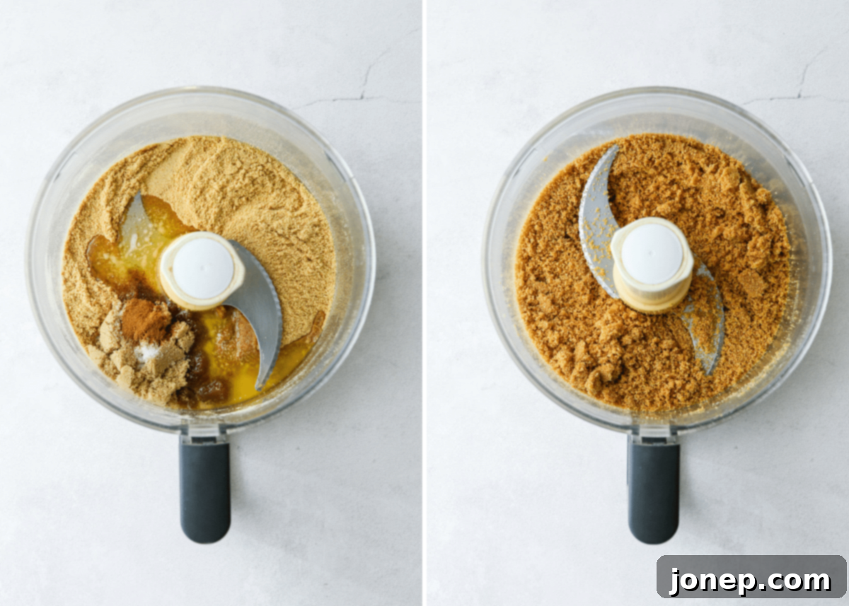Graham cracker crust mixture being combined in a food processor, showing the 'wet sand' texture.