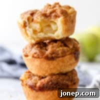 A small, perfectly baked mini sour cream apple pie with streusel topping.